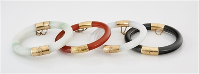 Group of Four 14K Yellow Gold, Jadeite and Hardstone Bangles